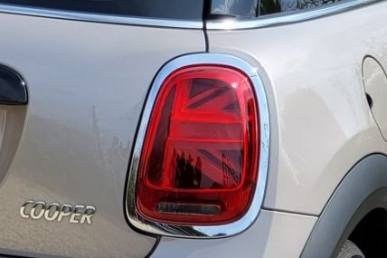 Red taillight of a car with a Union Jack design on the lens.