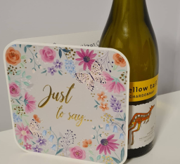 Gift box with floral design beside a bottle of wine labelled "Yellow Tail".