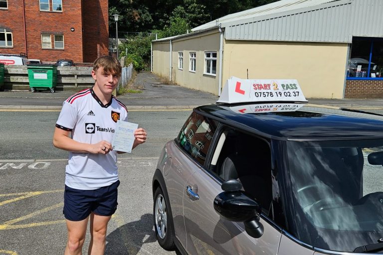 A young person in sports clothing holds a driving test certificate next to a car with a learner sign.